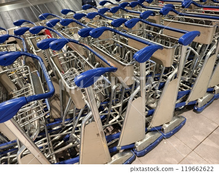 A large number of carts are neatly lined up in an airport 119662622