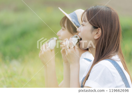 Young women taking a break during the rice harvest Young women taking a break during the rice harvest 119662696