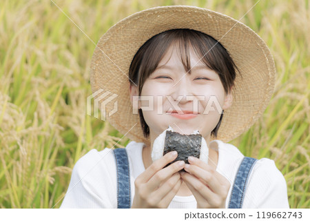 young woman eating rice balls young woman eating rice balls 119662743