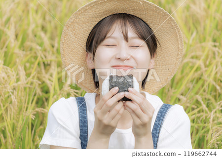 young woman eating rice balls 119662744