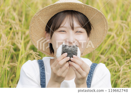 young woman eating rice balls 119662748
