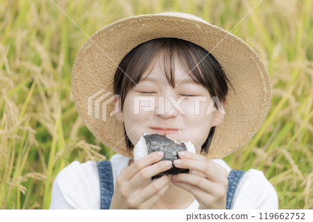 young woman eating rice balls young woman eating rice balls 119662752