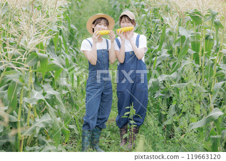 Young women standing with harvested vegetables Young women standing with harvested vegetables 119663120