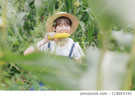 Young woman eating freshly harvested vegetables Young woman eating freshly harvested vegetables 119663342