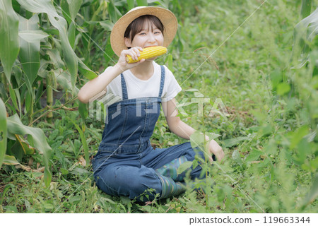 Young woman eating freshly harvested vegetables 119663344