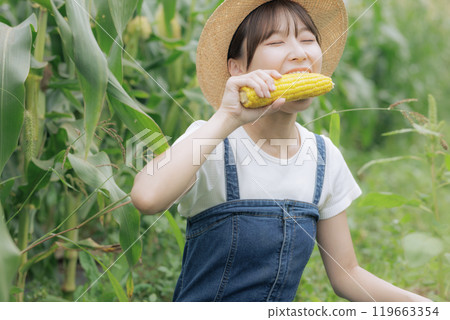 Young woman eating freshly harvested vegetables Young woman eating freshly harvested vegetables 119663354