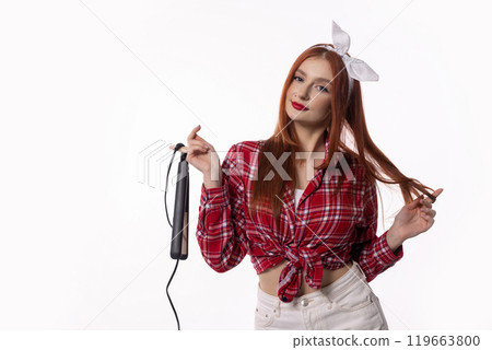 A Stylish Woman Holding a Hair Straightener, Dressed in a Chic Retro Outfit, Exuding Elegance 119663800