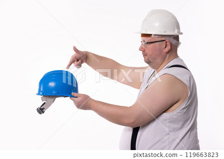 A dedicated Construction Worker equipped with Safety Helmets and protective gear at work A dedicated Construction Worker equipped with Safety Helmets and protective gear at work 119663823