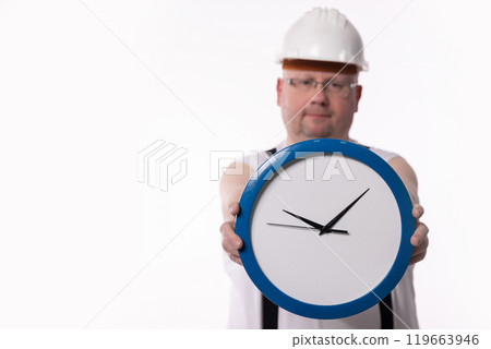A construction worker holds a clock, symbolizing their commitment to time management A construction worker holds a clock, symbolizing their commitment to time management 119663946