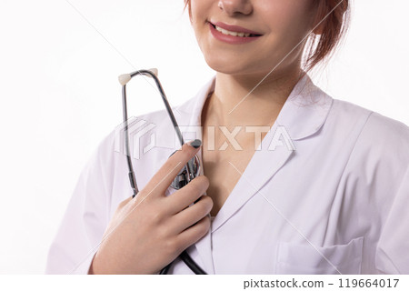A Female Healthcare Professional proudly holding a Stethoscope in her work environment 119664017