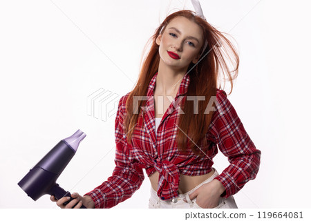 A Stylish Model Holding a Hair Dryer While Dressed in a Trendy Outfit Full of Personality 119664081