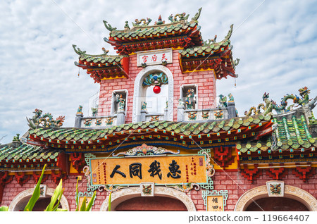 Beautiful ancient red Asian gate to Buddhist pagoda in old town in Hoi An in Vietnam in Asia 119664407