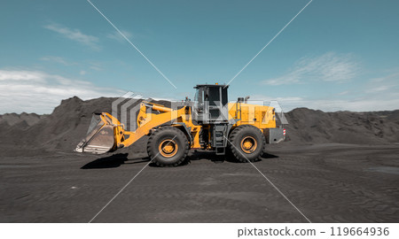 Loading of an loader into railway wagons. Excavator loading coal into wagons. Loading of coal truck using excavator. Shipment coal for transportation by rail 119664936