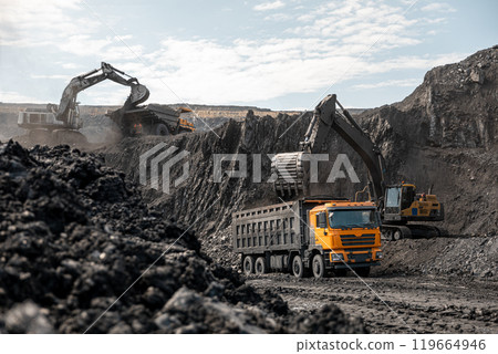 Large quarry dump truck and excavator. Big mining truck work coal deposit. Loading coal into body truck. Production useful minerals. Mining mining machinery to transport coal from open-pit production 119664946