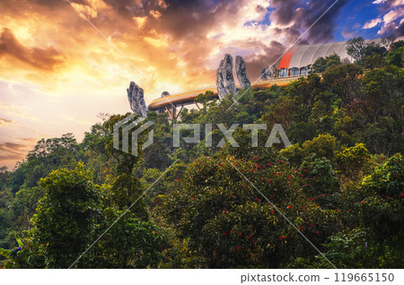 Golden Bridge of the Hand of God at Sun World Ba Na Hills amusement Park in Da Nang in Vietnam on the mountain at sunset in summer 119665150