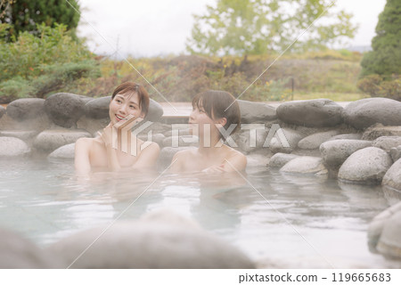 Young women relaxing in an open-air bath Young women relaxing in an open-air bath 119665683