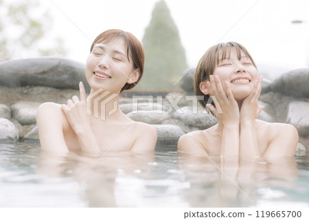 Young women relaxing in an open-air bath Young women relaxing in an open-air bath 119665700