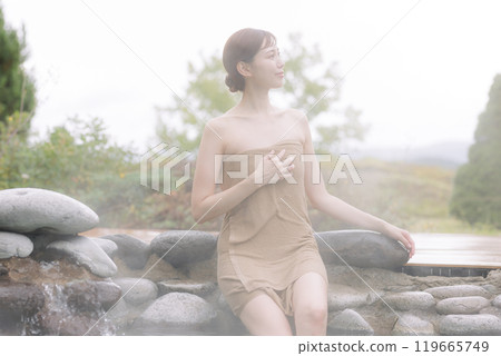 A young woman relaxing after getting out of an open-air bath 119665749