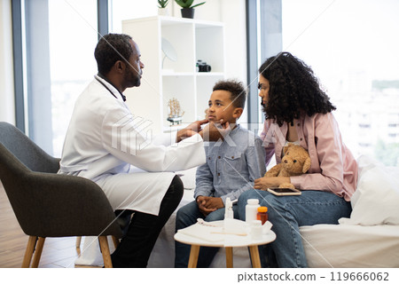 Doctor examining child's lymph nodes during medical check-up 119666062