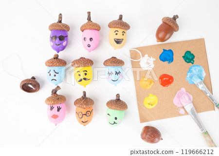 a collection of painted acorns arranged on a white background. top view. 119666212