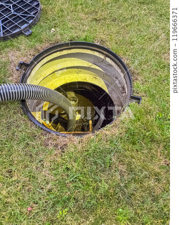 opened the sewer hatch and inserted a hose for cleaning the septic tank. High quality photo 119666371