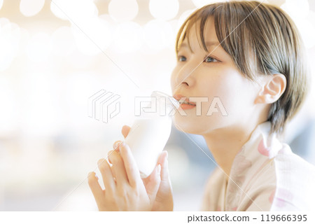 Young woman relaxing after a bath Young woman relaxing after a bath 119666395