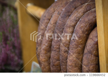 Fresh prepared smoked sausage with spices on market stall Fresh prepared smoked sausage with spices on market stall 119666432