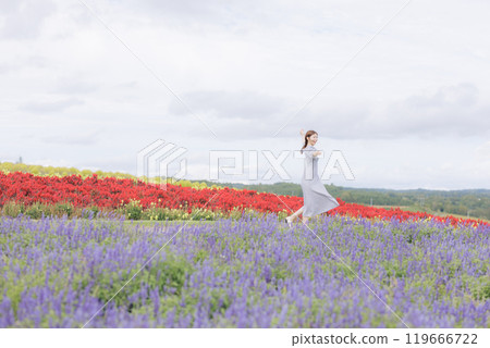 A woman walking through a flower field 119666722