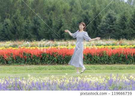 A woman walking through a flower field A woman walking through a flower field 119666739
