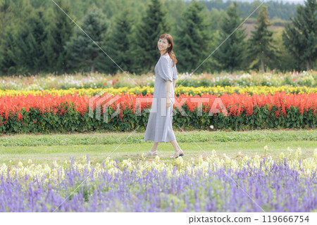 A woman walking through a flower field 119666754