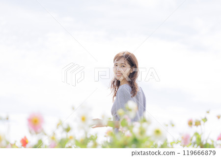 Woman taking a walk in the flower field Woman taking a walk in the flower field 119666879