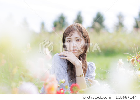 A woman surrounded by flowers A woman surrounded by flowers 119667144