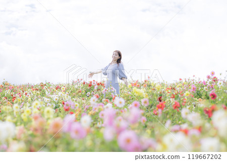 A woman happily strolling through a flower field A woman happily strolling through a flower field 119667202