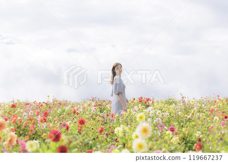 A woman happily strolling through a flower field 119667237