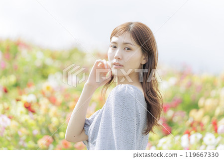 A woman surrounded by flowers A woman surrounded by flowers 119667330