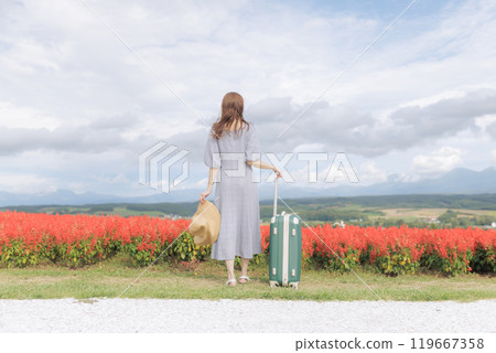 A woman standing in a cosmos field A woman standing in a cosmos field 119667358