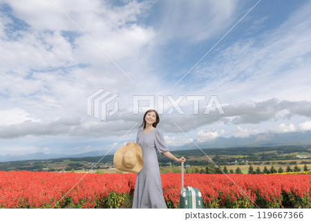 A woman standing in a cosmos field A woman standing in a cosmos field 119667366