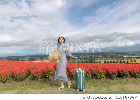 A woman standing in a cosmos field 119667367