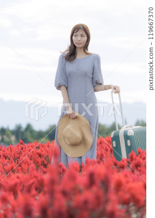 A woman standing in a cosmos field 119667370