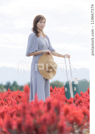 A woman standing in a cosmos field A woman standing in a cosmos field 119667374