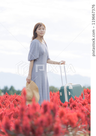 A woman standing in a cosmos field A woman standing in a cosmos field 119667376