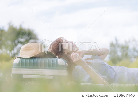 A woman lying down on the lawn A woman lying down on the lawn 119667440