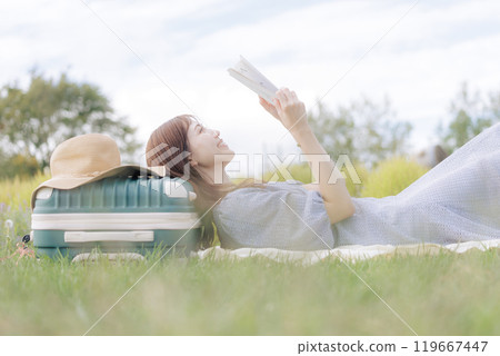 A woman lying down on the lawn 119667447