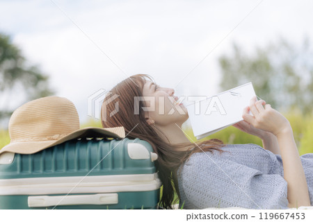 A woman lying down on the lawn A woman lying down on the lawn 119667453