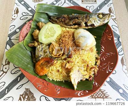 Nasi Kuning (yellow rice) is eaten during celebrations in Bali, Indonesia. Nasi Kuning (yellow rice) is eaten during celebrations in Bali, Indonesia. 119667726