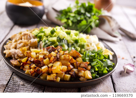 ingredients for salad. chicken, fried potato and vegetables ingredients for salad. chicken, fried potato and vegetables 119669370