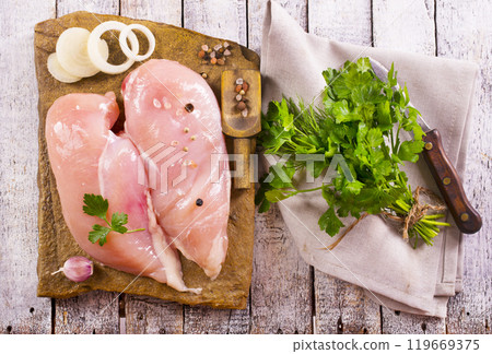 Raw chicken breast or fillet with salt, pepper and fresh herbs Raw chicken breast or fillet with salt, pepper and fresh herbs 119669375