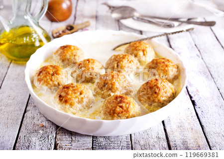 Baked chicken balls, meat balls with white sauce and cheese Baked chicken balls, meat balls with white sauce and cheese 119669381
