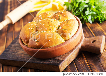 Homemade buns with garlic and dill on wooden table Homemade buns with garlic and dill on wooden table 119669391