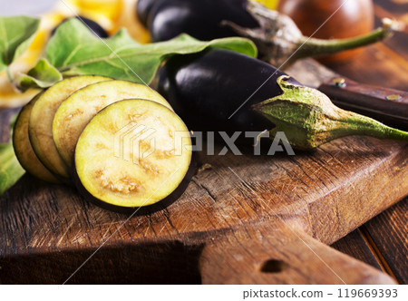 Sliced eggplant on wooden cutting board Sliced eggplant on wooden cutting board 119669393